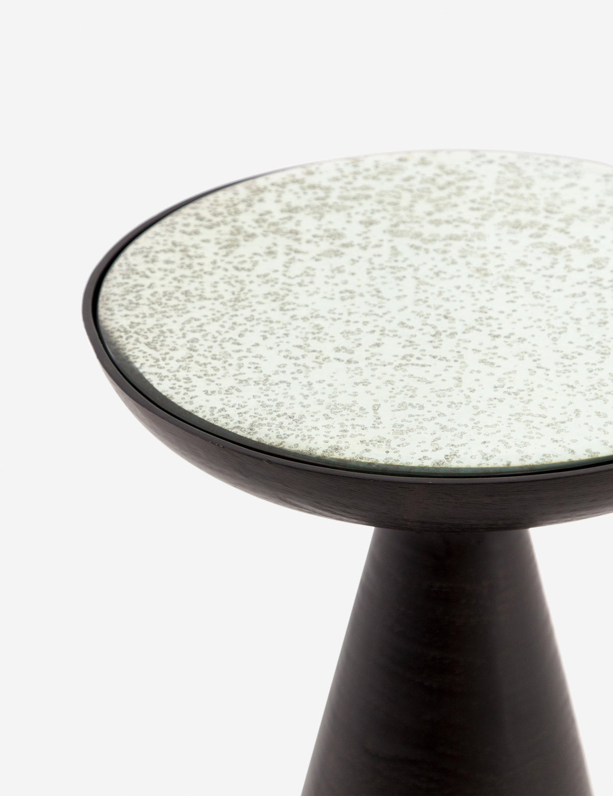 | Close-up of the upper-half of the Bridget bronze pedestal side table with mirror ash glass top