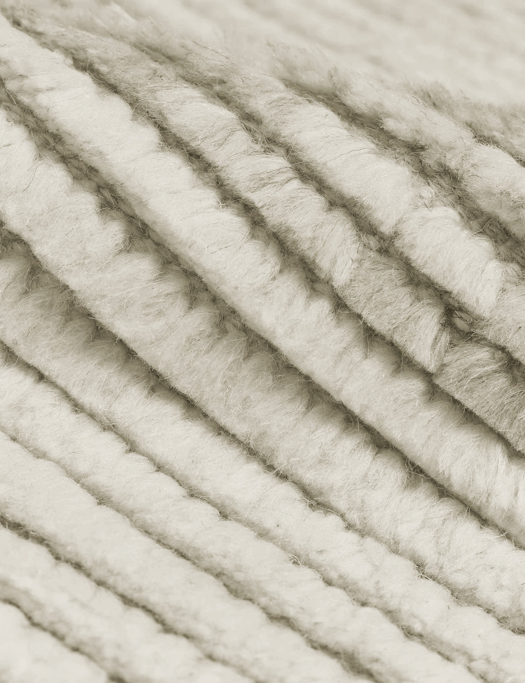 #size::2-6--x-8- #size::6--x-9- #size::8--x-10- #size::9--x-12- #size::10--x-14- #size::12--x-15- | Close-up of the two-toned ribbed fabric on the Nomad neutral-toned geometric floor rug by Élan Byrd