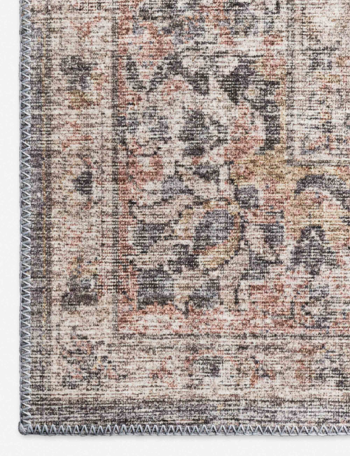 #color::grey-and-apricot #size::2-3--x-3-9- #size::2-6--x-7-6- #size::3-6--x-5-6- #size::5--x-7-6- #size::7-6--x-9-6- #size::9--x-12- | Close-up of the medallion patterns on the corner of the Roze grey and apricot power-loomed rug
