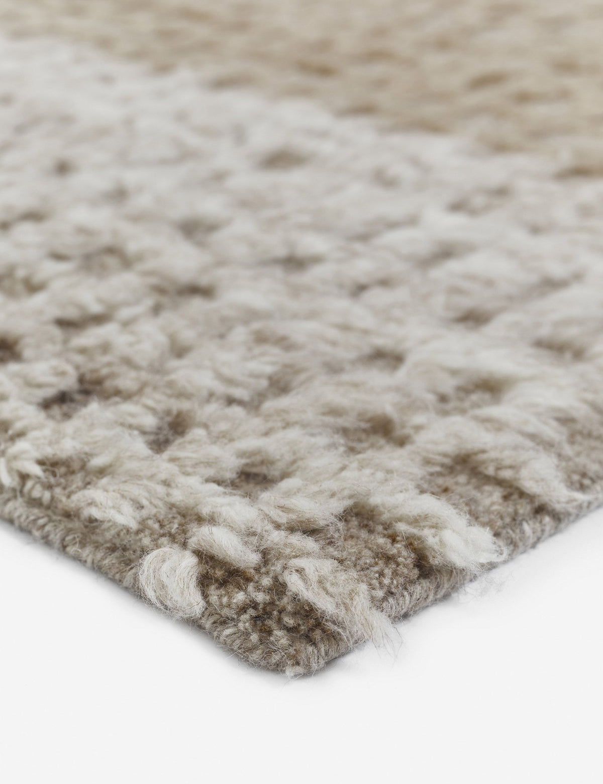 #size::6--x-9- #size::8--x-10- #size::9--x-12- #size::10--x-14- #size::12--x-15- | Close-up of the corner of the Terra handcrafted textured multicolored floor rug by Élan Byrd