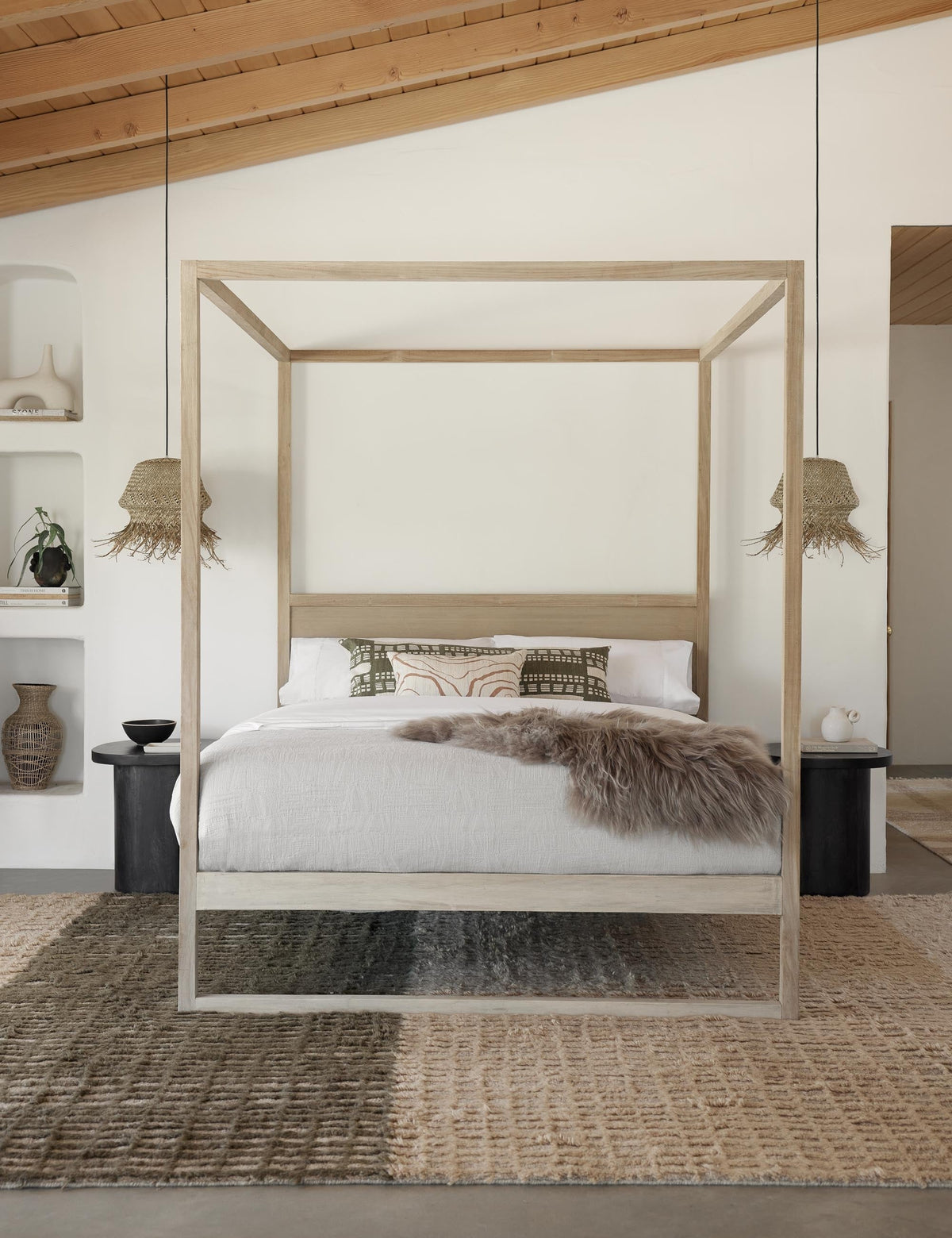 #size::6--x-9- #size::8--x-10- #size::9--x-12- #size::10--x-14- #size::12--x-15- | The Terra handcrafted textured multicolored floor rug by Élan Byrd sits in a bedroom with a light wooden framed canopy bed, two jute pendant lights, and two black wooden nightstands